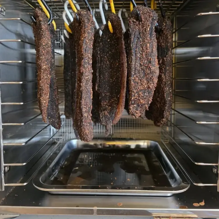 Spiced beef biltong hanging inside a Kalahari Khabu Biltong Boss