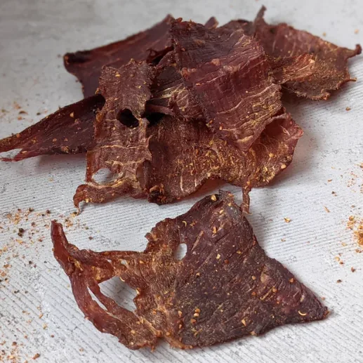Thin sliced biltong leaves dried in a Kalahari Khabu Biltong Boss