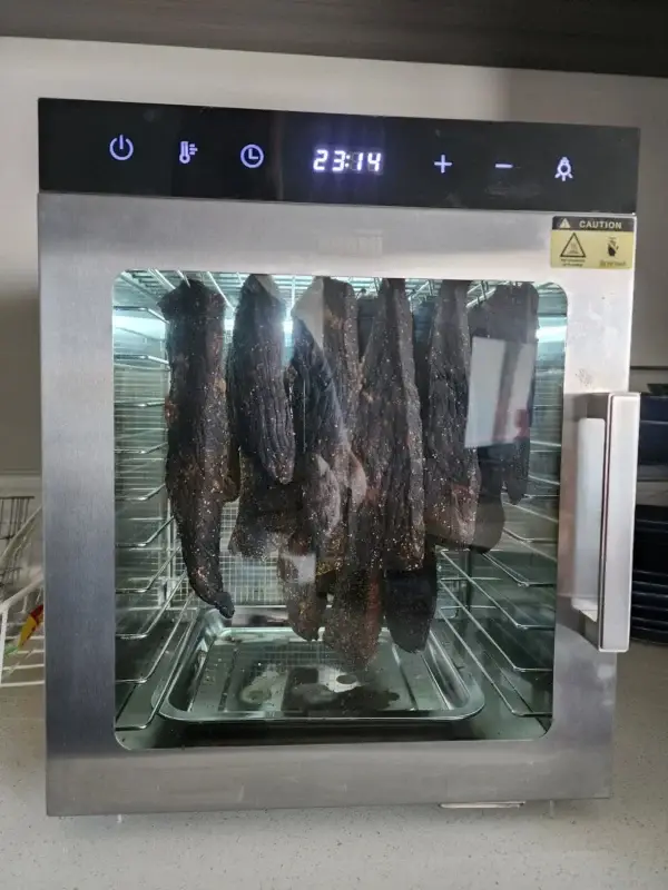 Biltong hanging on hooks inside the Kalahari Khabu Biltong Boss KK11